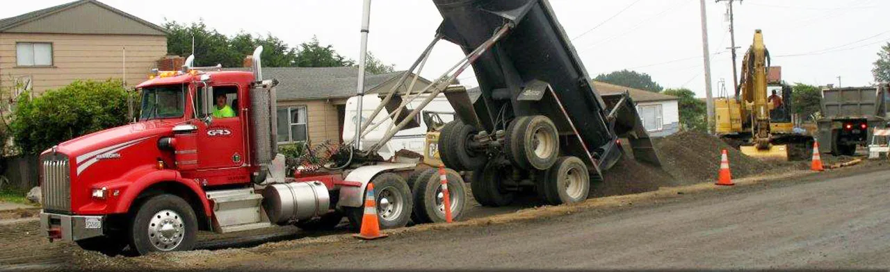 A G.R. Sundberg lowboy trailer hauling equipment